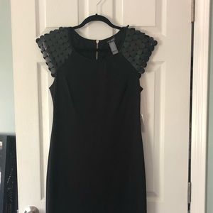 Fitted knee length dress with shoulder detail.